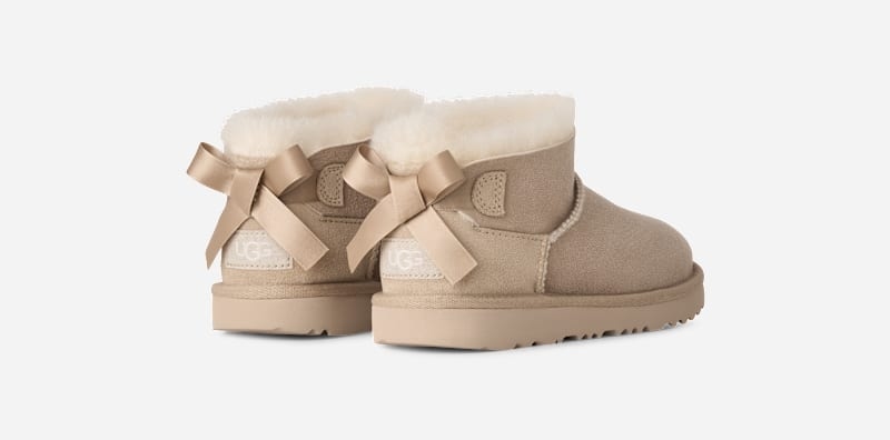 UGG® Ultra Mini Bailey Bow Boot 'Sand' 1185920K-SAN