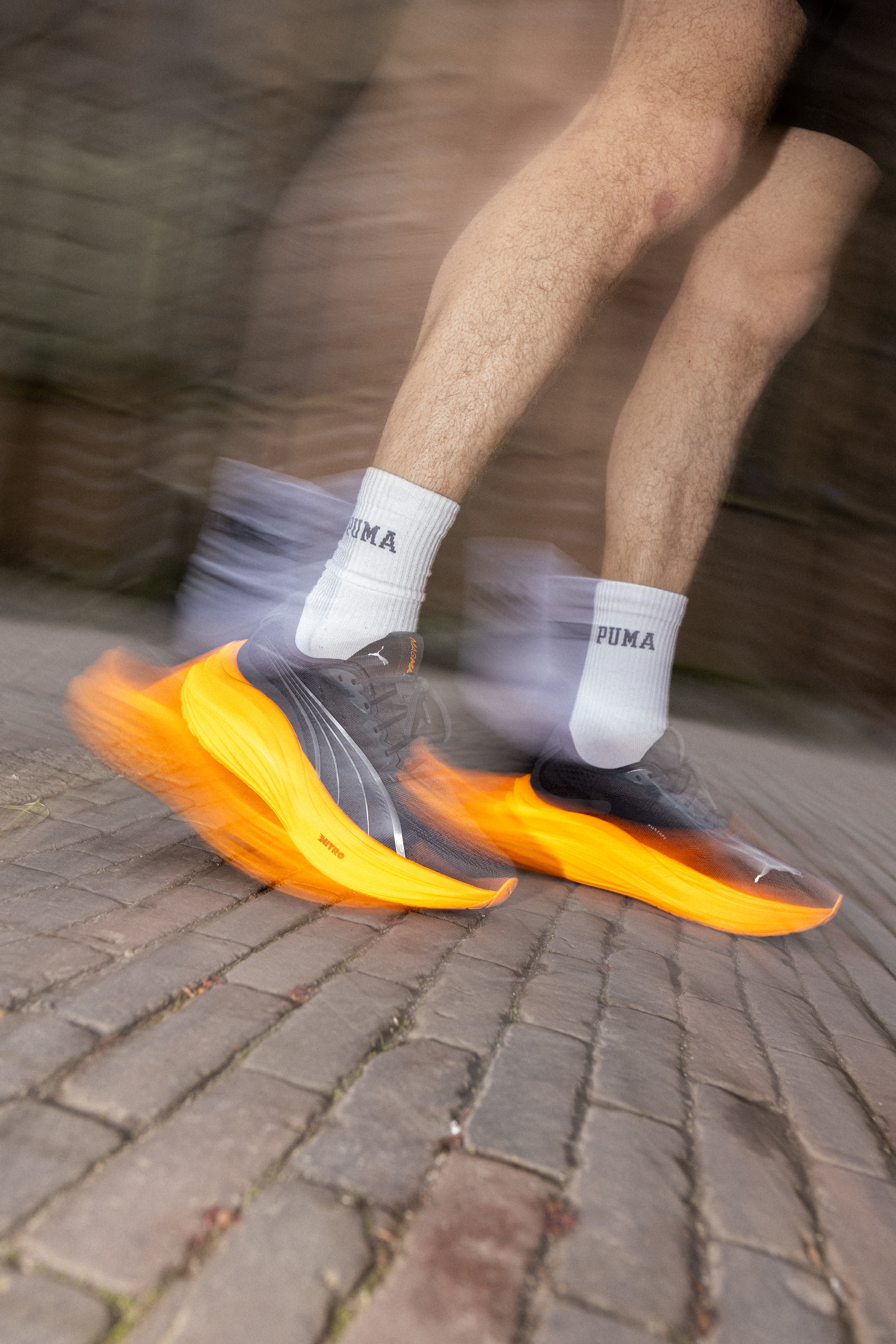 PUMA running sneaker in a black and orange colorway