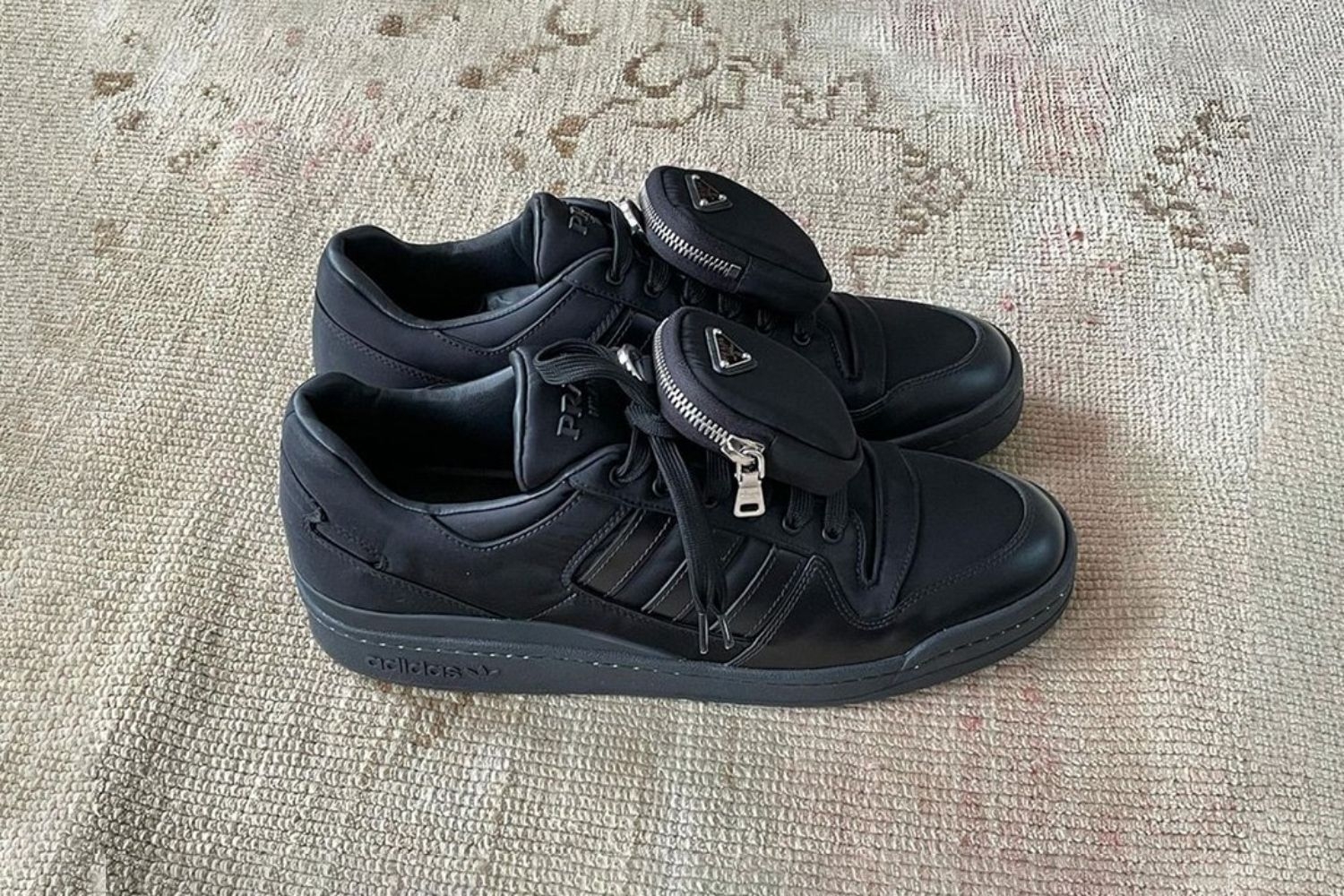 Check out the first images of the PRADA x adidas Forum Low 'Triple Black' here