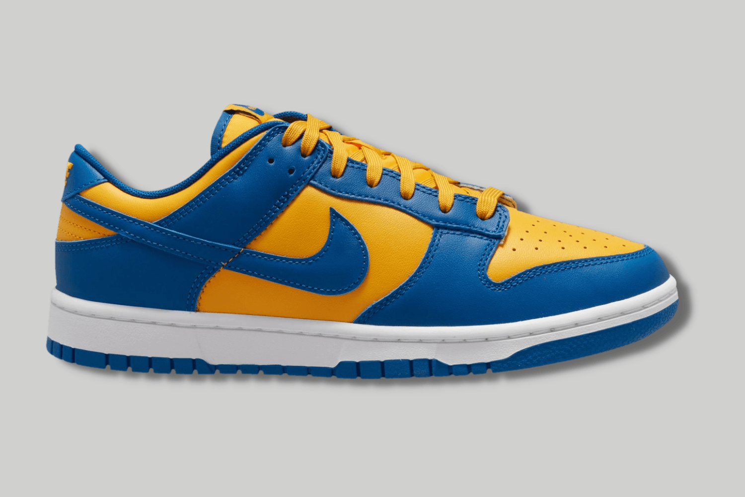 The Nike Dunk Low appears in a 'UCLA' colorway