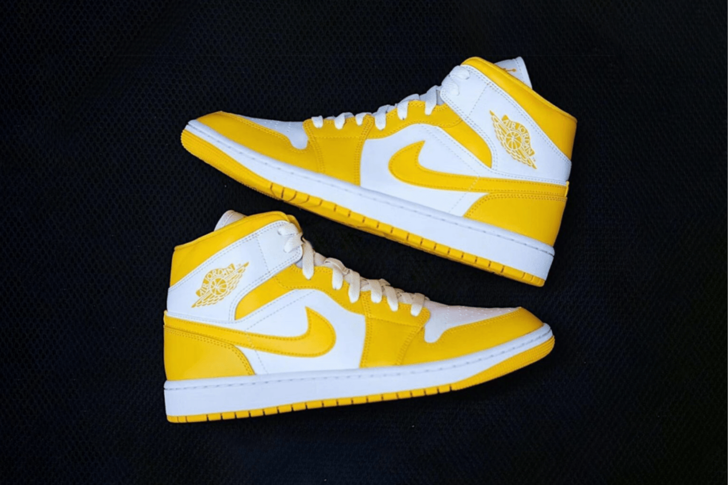 The Air Jordan 1 Mid comes in yellow and white