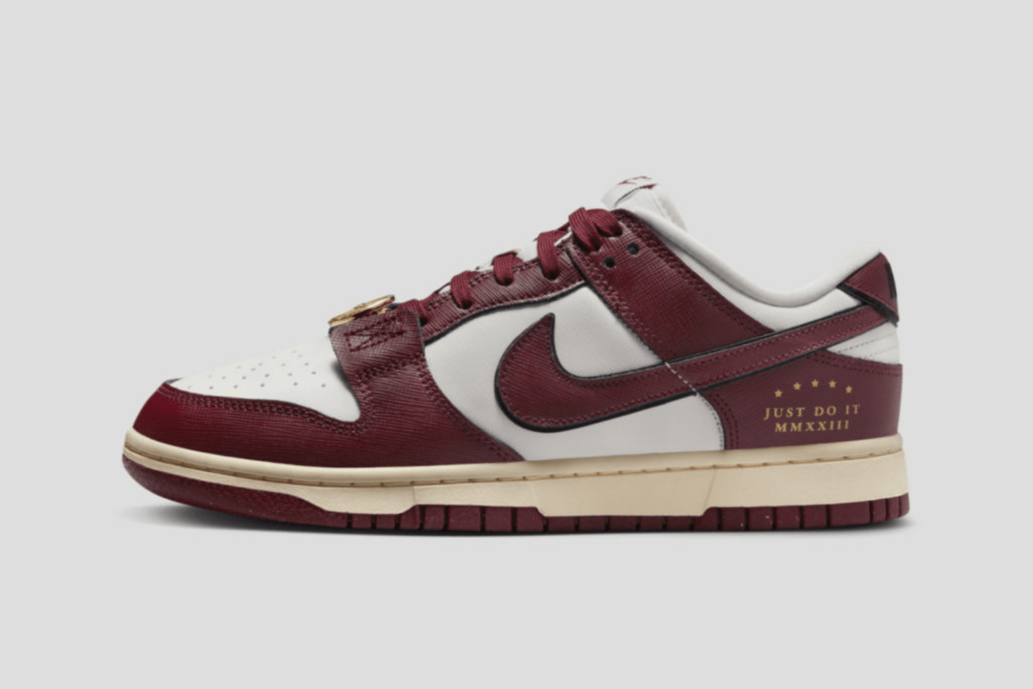 The Nike Dunk Low 'Team Red' comes with gold accents