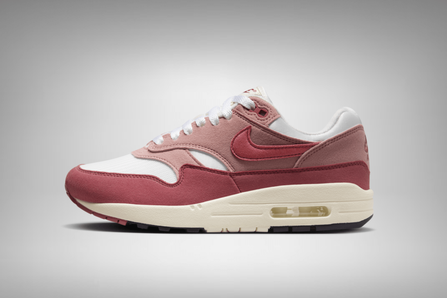 The Nike Air Max 1 appears in a 'Red Stardust' colorway